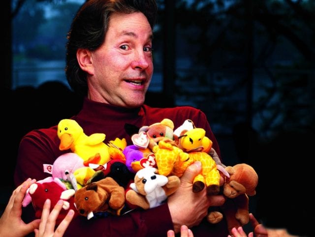 Hands reaching up to grab Beanie Babies from their creator, toy mogul H. Ty Warner.(Photo by Kevin Horan/The LIFE Images Collection/Getty Images)